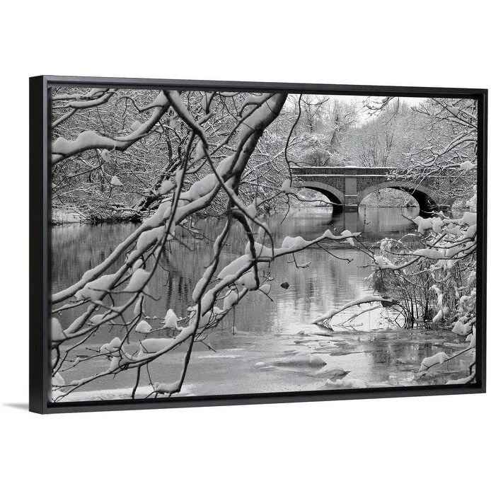 "Arch bridge over partially frozen river seen trough snow covered branches." Black Float Frame Canvas Art